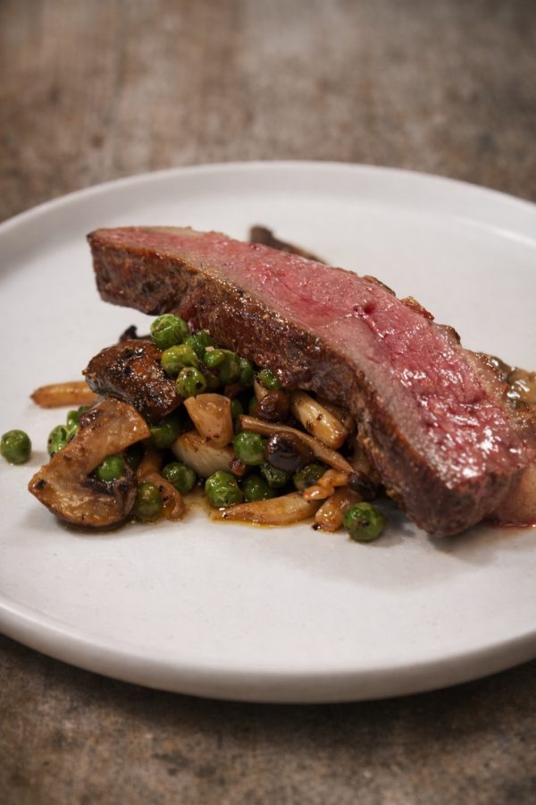 Duck breast with peas and mushrooms